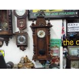 A Vienna style wall clock, walnut case flanked by decorative turned columns,