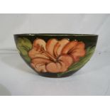 Moorcroft Pottery - A medium Moorcroft pottery oval bowl decorated with hibiscus on a green ground,