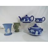 Wedgwood - Five pieces of Wedgwood Jasperware comprising three dark blue items to include teapot,