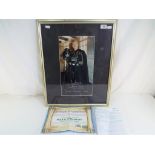 A photograph of Dave Prowse as Darth Vader mounted and framed under glass bearing signature