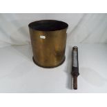 A large German World War One (WWI) brass howitzer shell case, marked to the base 101,