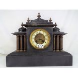 An imposing French black marble mantel clock, the case style influenced by classical architecture,