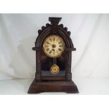 An early 20th century beehive style shelf clock, the case with glazed opening door,