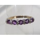 A lady's 9 carat gold hallmarked stone set eternity ring size T and a half, approximate weight 2.