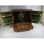 A small wooden drinks cabinet covered in embossed leather,