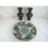 An Oriental charger hand painted decoration depicting Cylin and floral motifs,