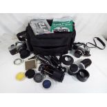 A waterproof camera case containing a Nikkormat FT2 and a Nikkormat FTN body with a collection of