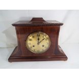 An unusual early 20th century polished mahogany cased mantel clock,