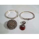 A collection of silver costume jewellery to include bangles, a mourning brooch,