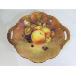 Coalport - A Coalport twin handled plate, hand painted in the Fallen Fruits design, signed R Budd,