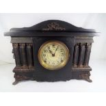 An ebonised wood cased American mantel clock intended to emulate the French black marble clocks,