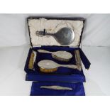 A George V silver hallmarked dressing table set, Birmingham assay 1919, comprising mirror,