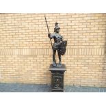 A large spelter figure depicting a Greek soldier standing on plinth,