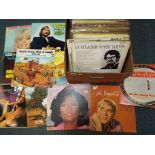 A large quantity of 33 rpm vinyl records to include Roger Miller, Tex Williams, ABBA, James Last,