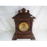 A good walnut cased American mantel clock, the case with carved an incised decoration,