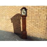 A good oak cased long case clock, Roman numeral on a silvered chapter ring,