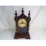 An early 20th century shelf clock, the case with glazed opening door,