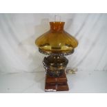 A decorative table lamp in the style of an oil lamp,