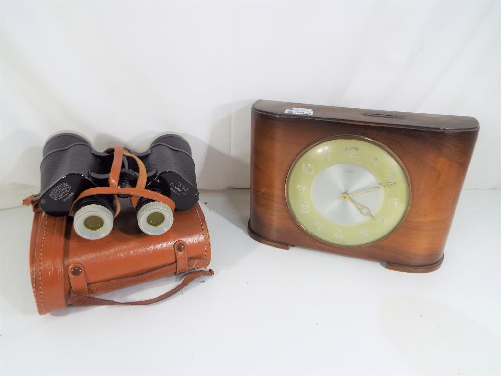 A Town Savings Clock (Two Florins Weekly) and a pair of Orpheus 7 x 50 zoom binoculars with carry