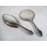 A George V hallmarked silver hand brush and mirror,