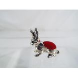 A silver pin cushion in the form of a rabbit Est £30 - £40