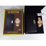 A lady's watch and and purse gift set contained in original box marked Michael Kors.