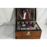 A lady's Victorian travelling vanity set in fitted case, pull-out tray and single drawer,