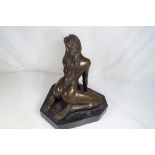 A hot cast bronze depicting a female nude set on an Italian marble plinth,
