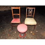 Two Edwardian chairs with upholstered seats and a small round stool,