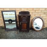 A bedside cabinet and two mirrors.