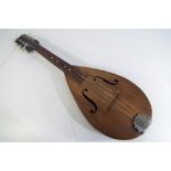 An eight string mandolin with carry case, length of body 33 cm, overall length 59.5 cm.