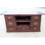 An Oriental fruitwood side cabinet having fitted drawers 73 cm x 132 cm x 50 cm.