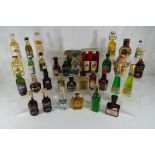 Thirty three miniature / taster bottles of whisky and other alcoholic beverages.