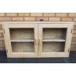 An antique pine wall mounted glass fronted barbers cabinet approx 59cms x 104cms x 18cms