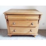 An antique pine chest of three drawers,