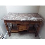 A marble topped pine wash stand the supports terminating in casters,