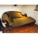 A chaise longue with carved mahogany detail, upholstered in olive green,
