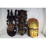 Three heavy good quality African tribal masks, two with micro beaded detailing,