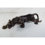 A cast bronzed figure of a panther.