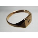 A gentleman's 9 carat gold ring set with single diamond chip, approximate size X and a half,