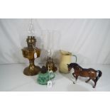 A small collection of oil lamps, a Beswick horse and a Kockums enamel jug.