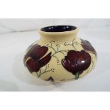 A Moorcroft vase in the Chocolate Cosmos pattern approx 7.5 cm (h).