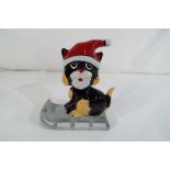 A Lorna Bailey cat on a sledge.