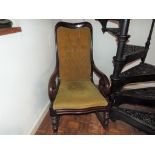 An oak framed rocking chair with mustard coloured upholstery