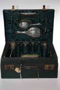Green hide dressing case with silver topped toilet bottles and brush set
