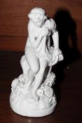 White glazed figure of naked maiden on a rock