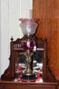 Brass cherub oil lamp with ruby glass reservoir