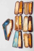 Six amber mounted cigar holders, all cased,