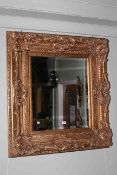 Heavy gilt framed bevelled wall mirror
