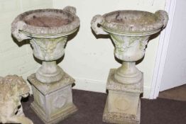 Pair weathered two handled campana style garden urns and stands